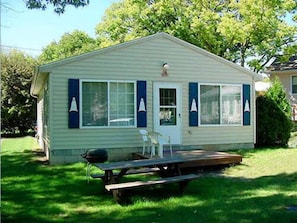 Enjoy a home away from home with a cozy porch and grill area.