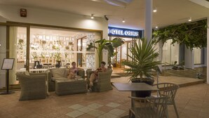 A hotel lobby with a seating area, a staircase, and a sign for 'HOTEL OSIRIS'. - Hotel Osiris Ibiza (Sant Antoni de Portmany)