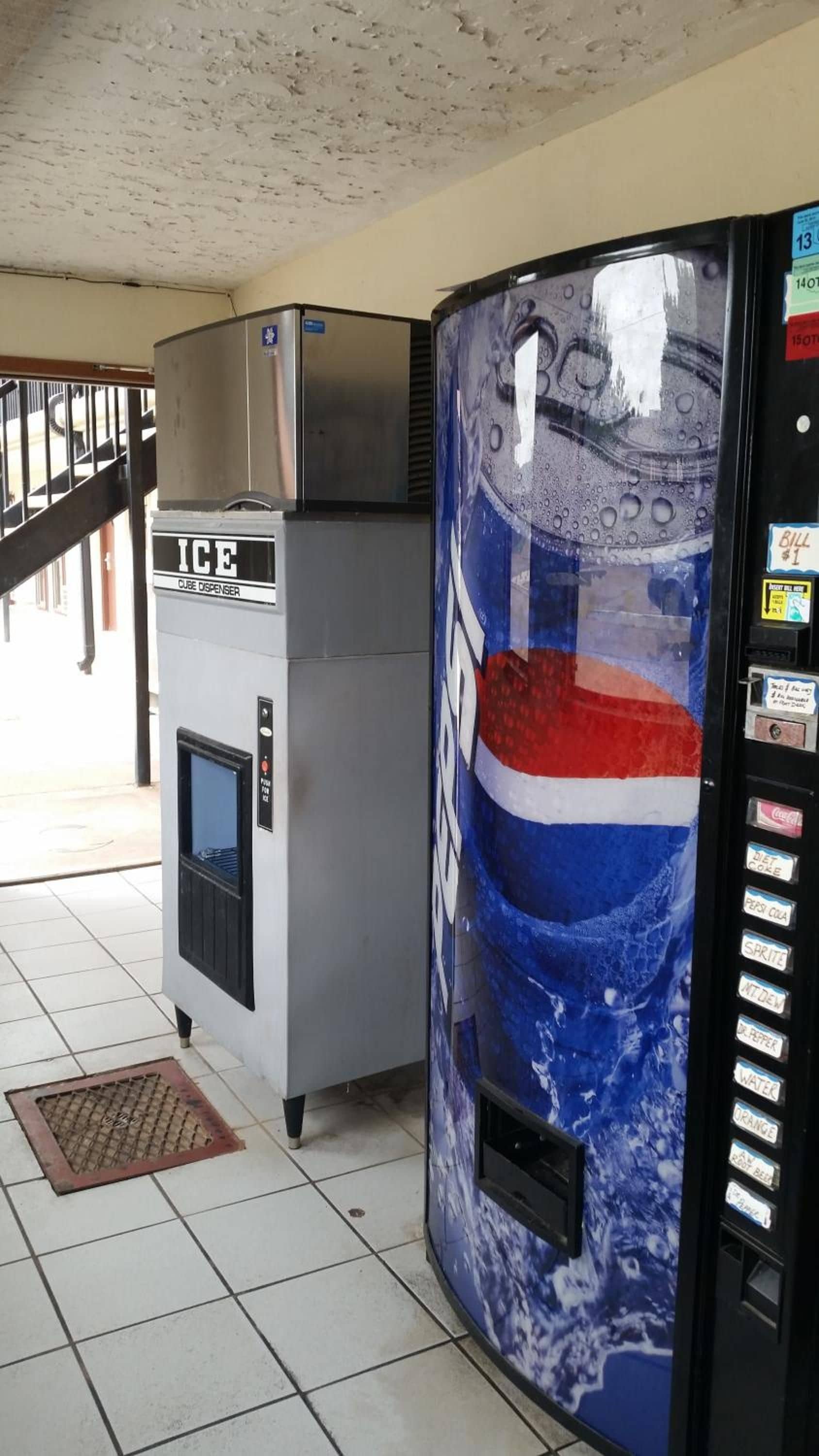 A vending machine with a Pepsi logo and a water dispenser with an ice cube dispenser.