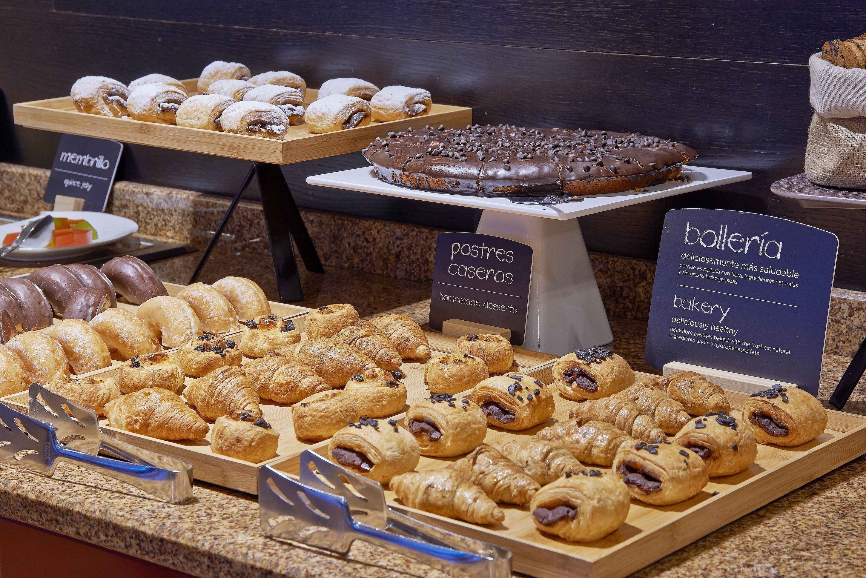 A bakery display with various pastries and desserts.