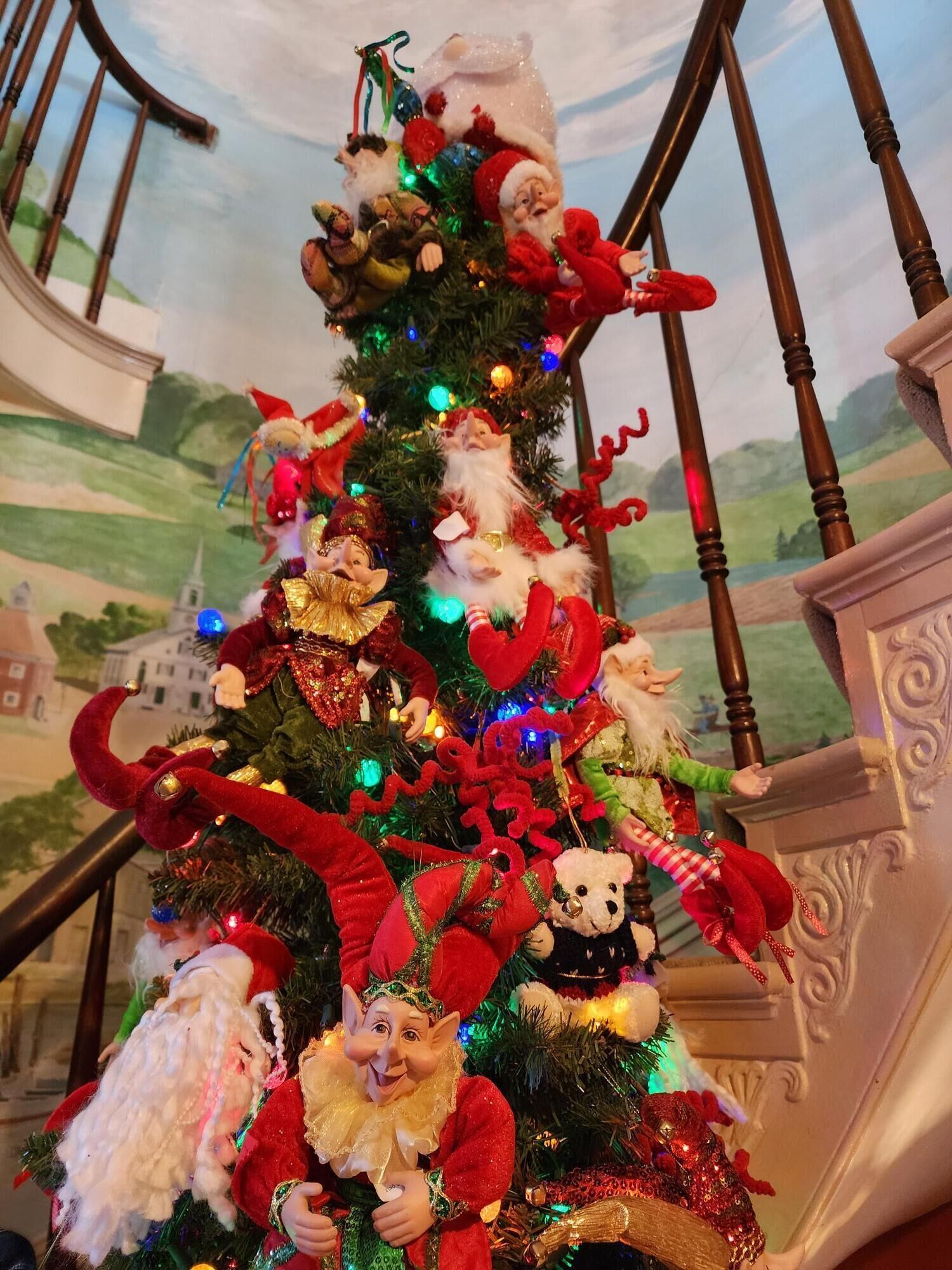 A Christmas tree with various ornaments and decorations.