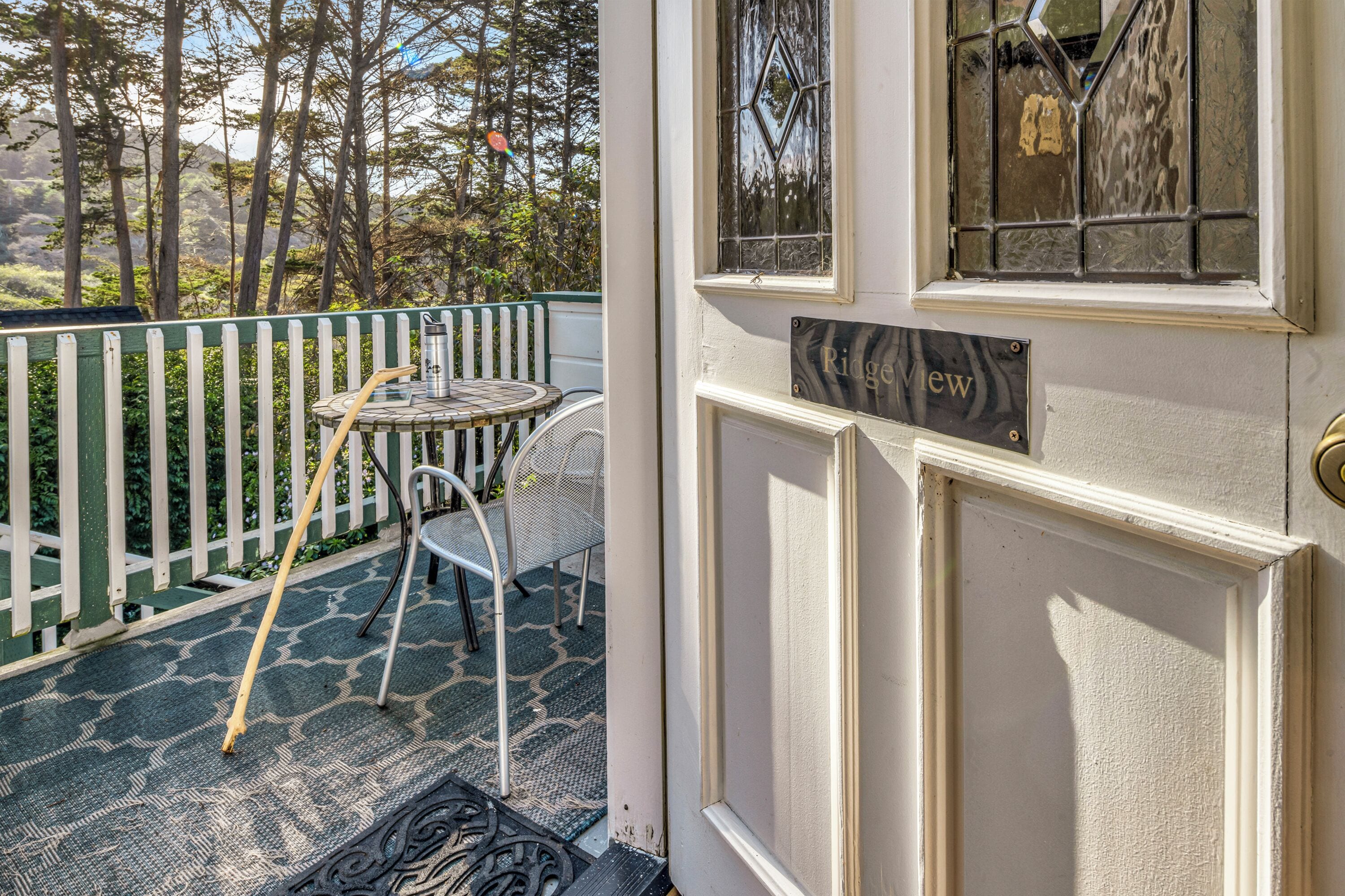 A door with a nameplate reading "Ridgeview" and a small table with chairs outside.