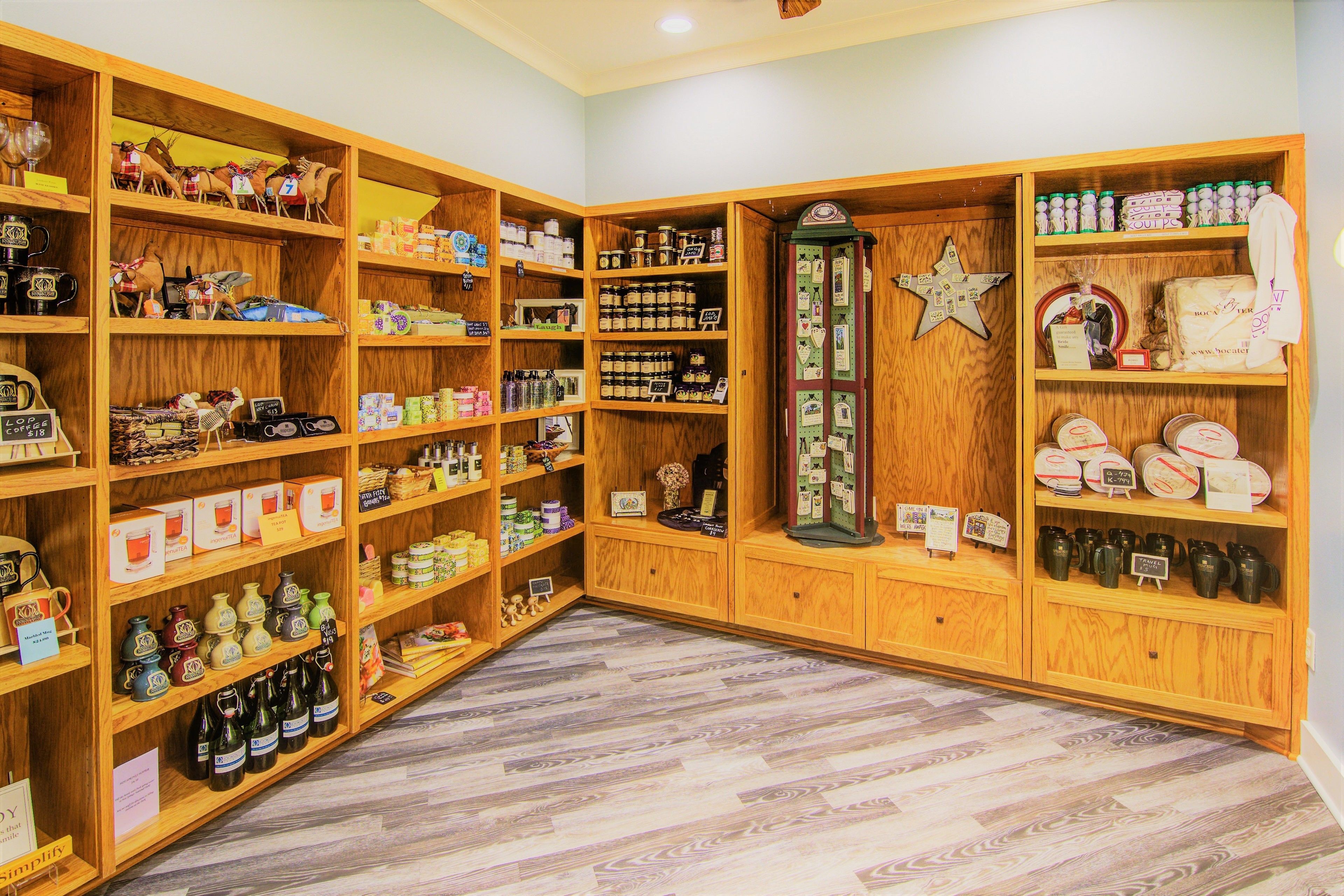 A store with wooden shelves stocked with various items like bottles, jars, and decorative objects.