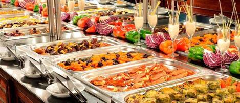 A buffet with various food items and drinks.