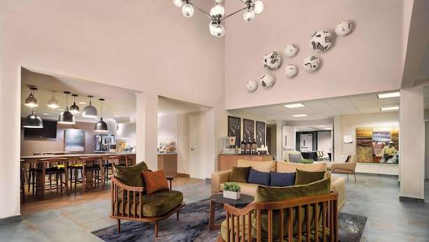 A spacious living area with a kitchen, dining area, and seating with a view of the city. - Fairfield Inn & Suites by Marriott Napa American Canyon (American Canyon)