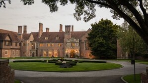A large, historic building with multiple chimneys, a well-maintained lawn, and a formal entrance. - Royal Park Hotel (Rochester)