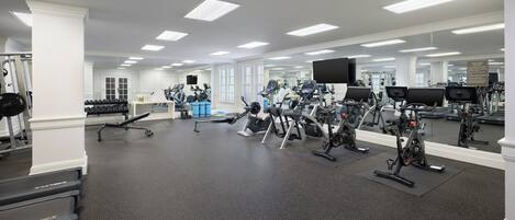 A gym with various exercise equipment, including treadmills and weight machines.