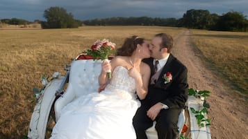 Couples can sit together on a bench amidst a serene countryside setting.