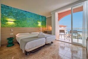 A hotel room with two beds, a balcony with a view, a green side table, and a large abstract painting on the wall. - Canyamel Classic & Spa, solo Adultos (Capdepera)