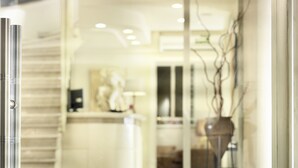 A hotel entrance with a glass door displaying the name "HOTEL ADRIAN". - Adrian Hotel (Athens)