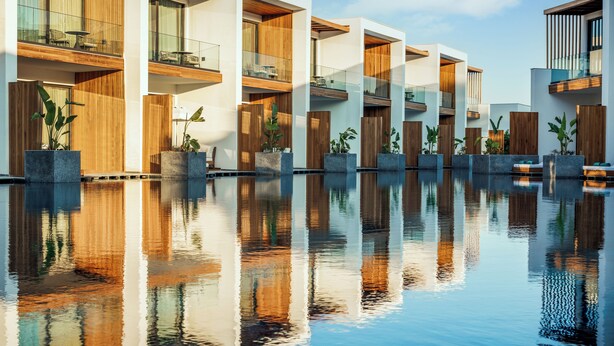 A modern hotel with a pool reflecting the building's architecture. - Sirene Belek Hotel (Serik)