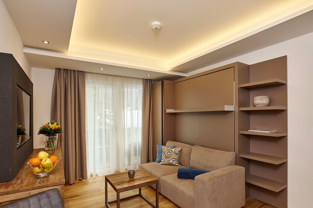 A modern living room with a sofa, coffee table, and built-in shelves.