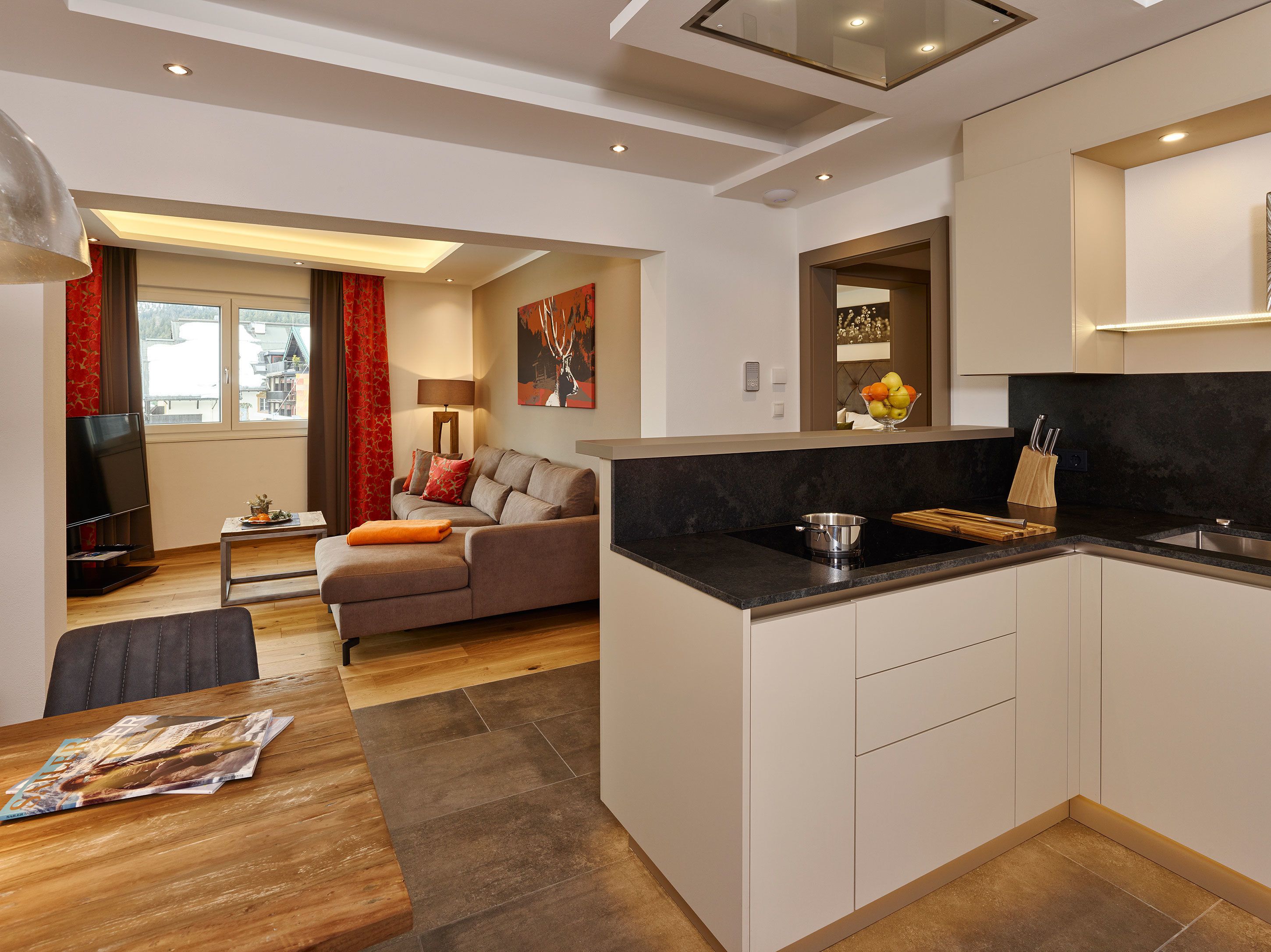 A modern apartment with a kitchen, dining area, and living room.