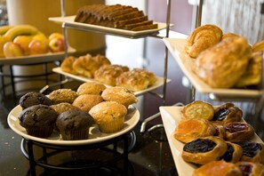 Indulge in a selection of freshly baked treats, including muffins, croissants, and pastries.
