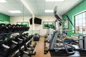 Stay fit on the go with our well-equipped gym featuring dumbbells, a medicine ball, and cardio machines.