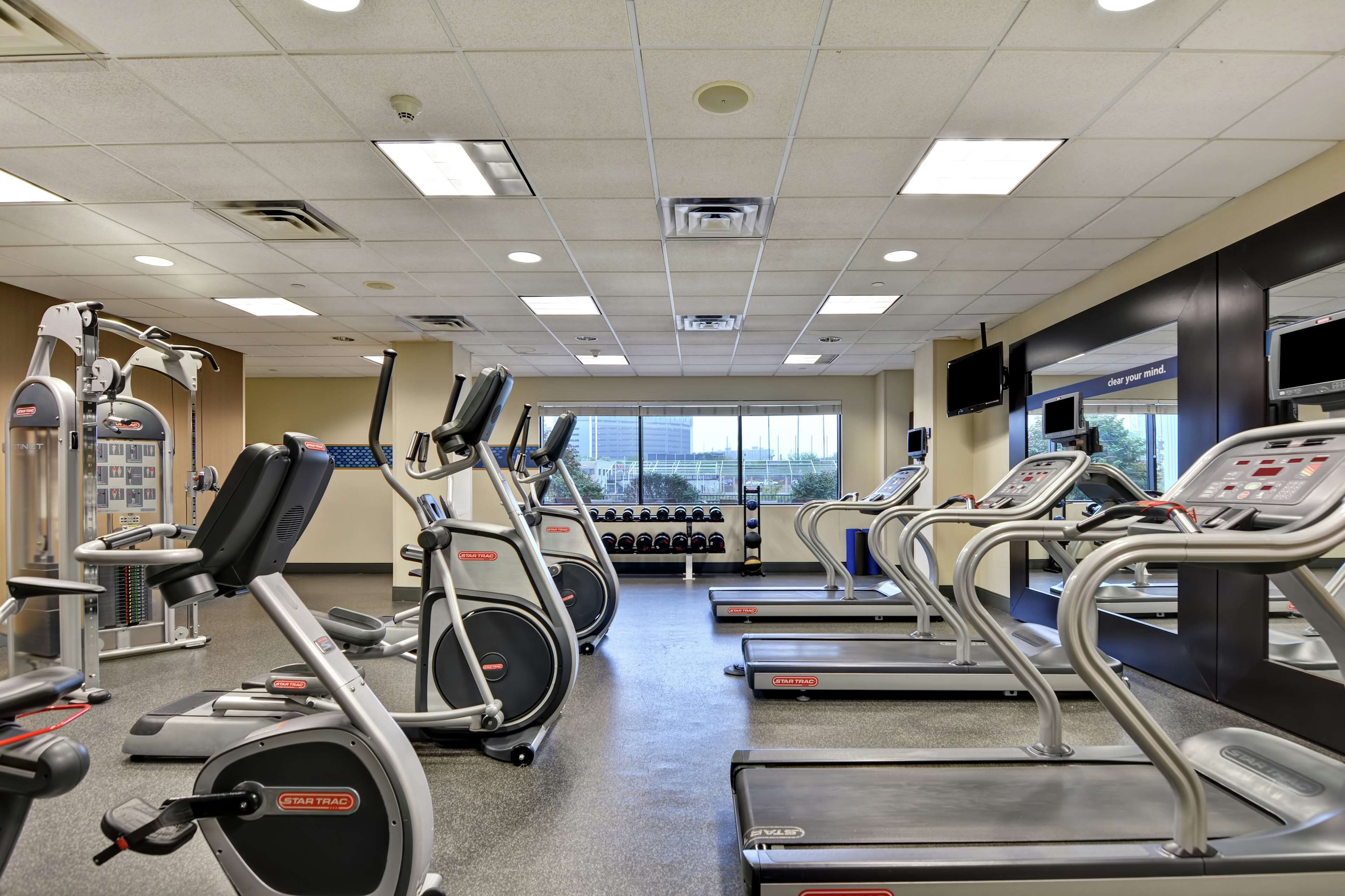 A gym with treadmills, elliptical machines, and weight machines.