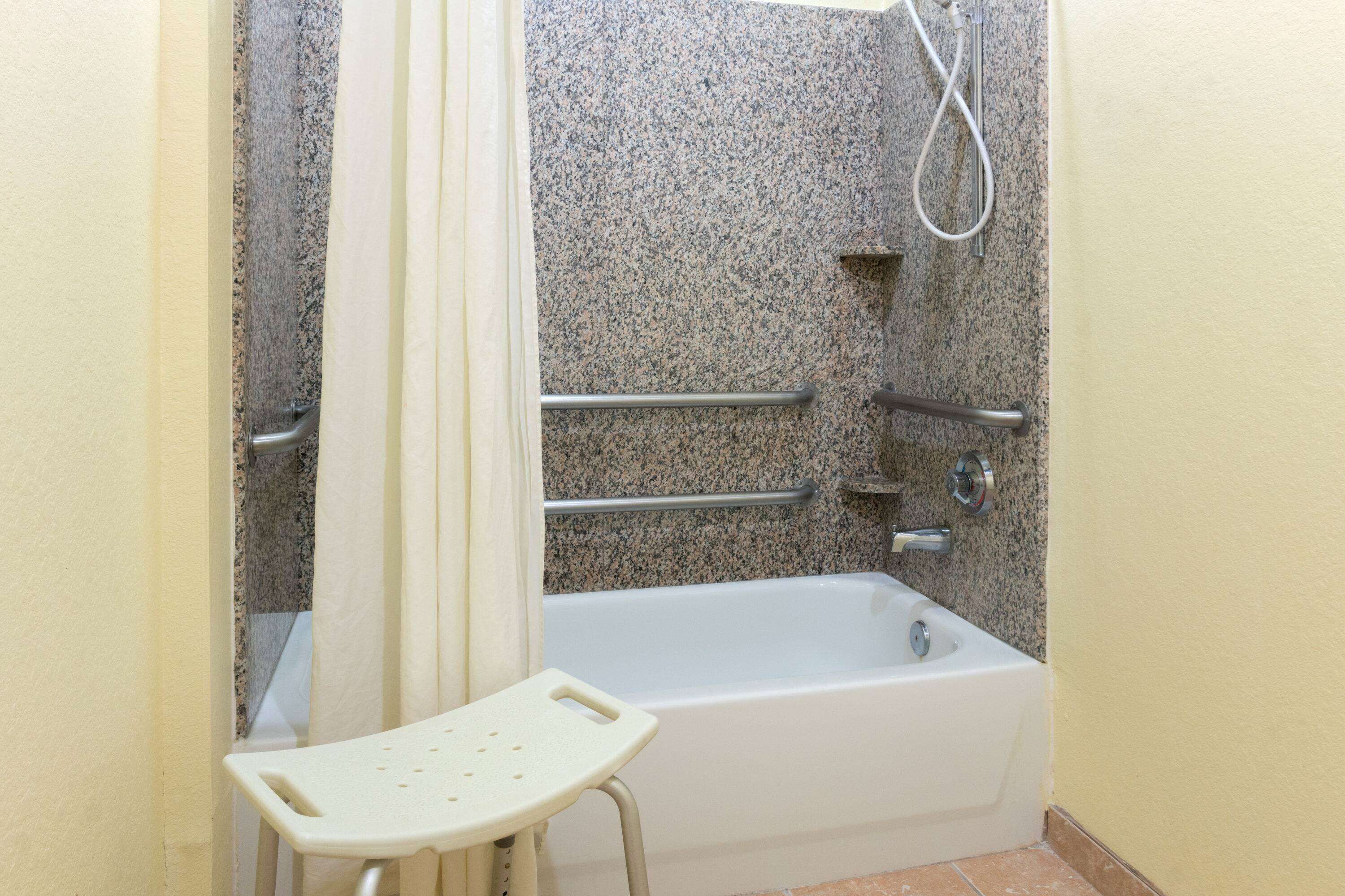 combined shower/bathtub, designer toiletries, hair dryer, towels