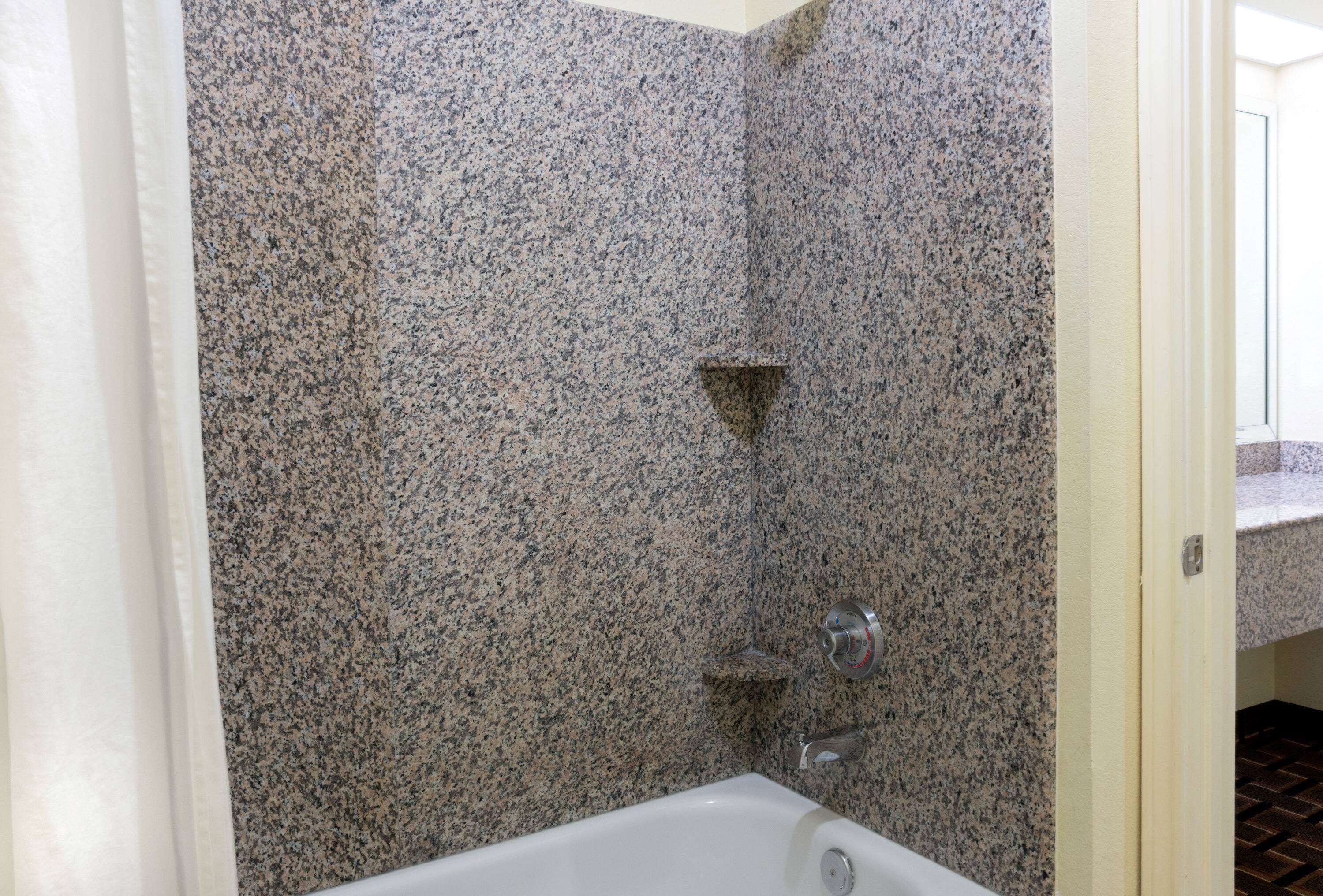 combined shower/bathtub, designer toiletries, hair dryer, towels