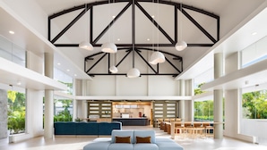 A spacious lobby with a high ceiling, modern furniture, and large windows. - Hyatt Centric San Juan - Isla Verde (Carolina)