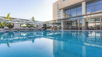 Seasonal outdoor pool, open 10:00 AM to 6:00 PM, pool umbrellas