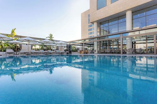 Seasonal outdoor pool, open 10:00 AM to 6:00 PM, pool umbrellas