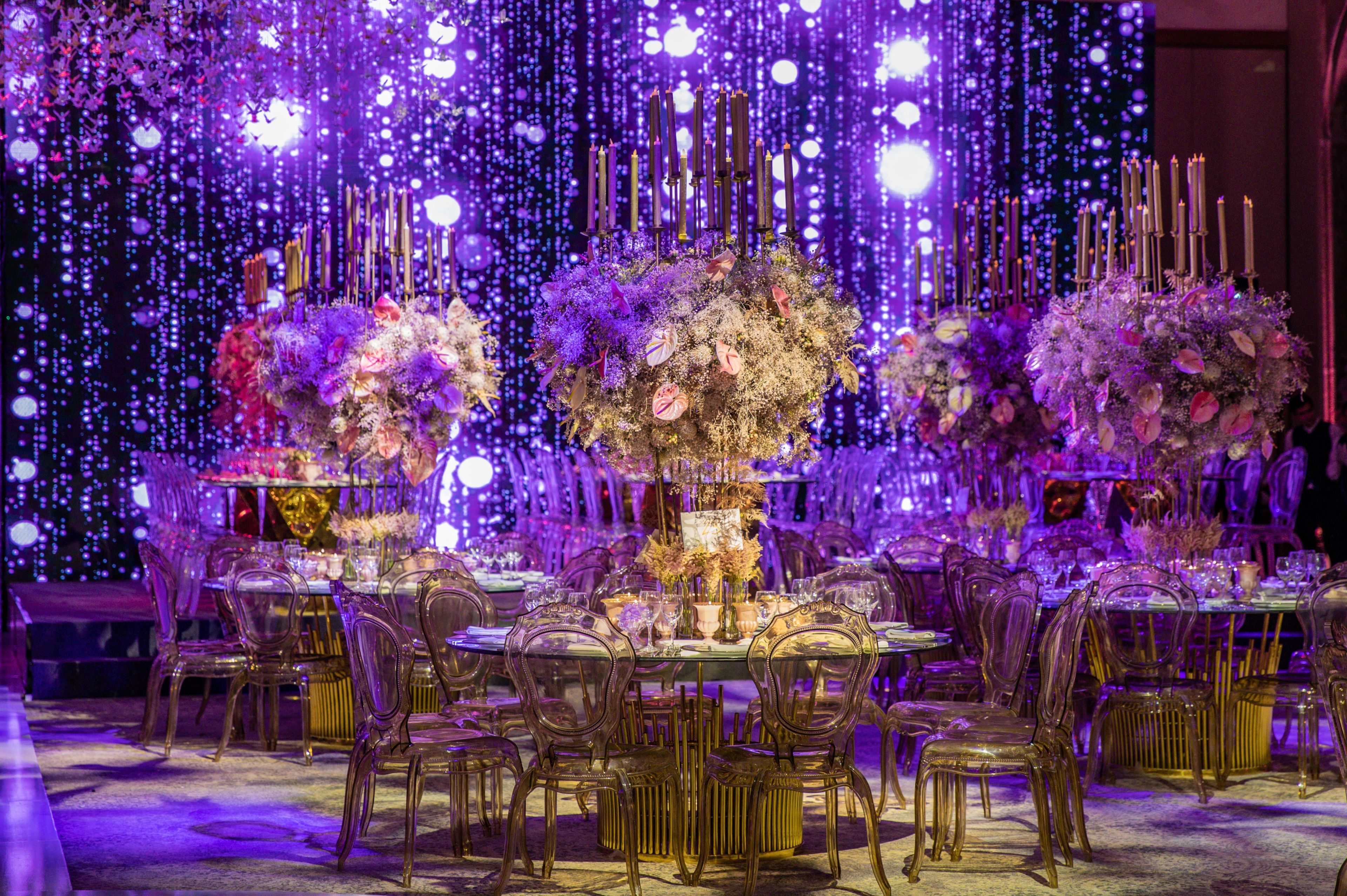 A formal dining setup with a table set for multiple guests, surrounded by chairs.