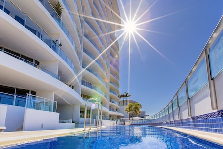 Outdoor pool, pool loungers. The Sebel Maroochydore