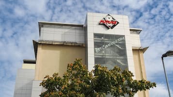 A hotel with a modern design, featuring a prominent sign with a clock and the name 'FUTURE INN'.
