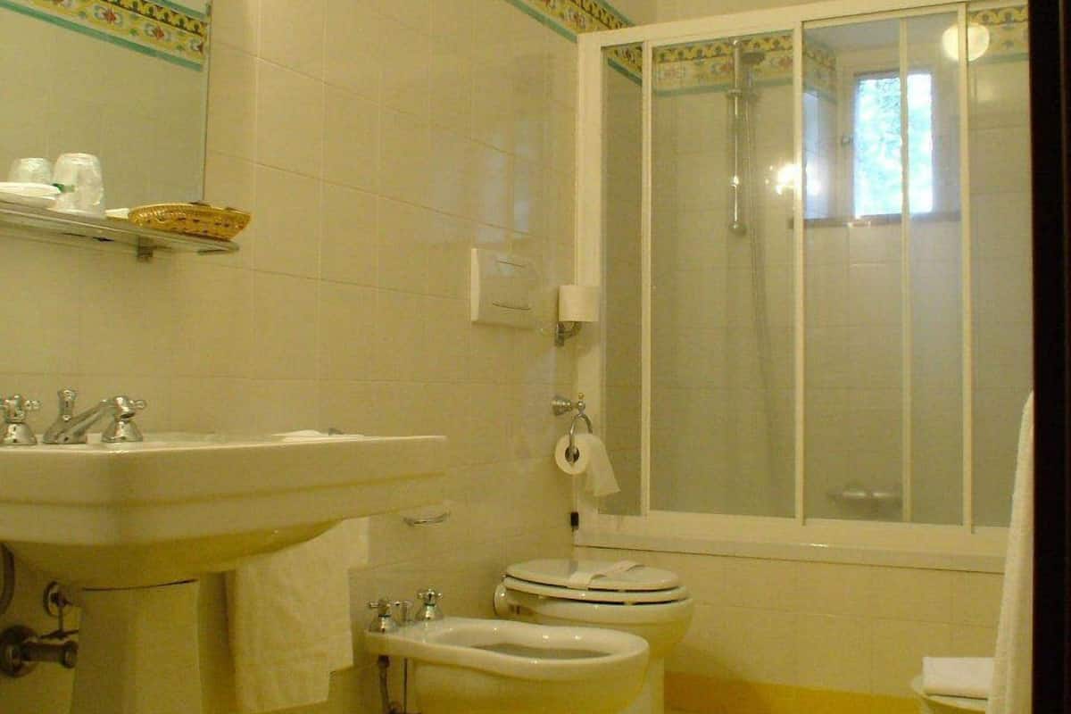 hair dryer, slippers, bidet, towels