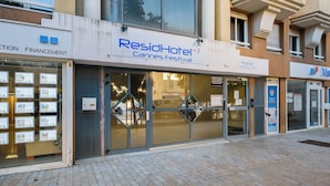 A hotel with a sign for 'ResidHotel Cannes Festival'.