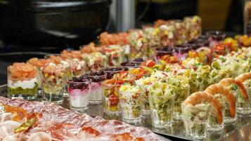 A variety of food items including shrimp, salads, and other appetizers arranged on a tray.