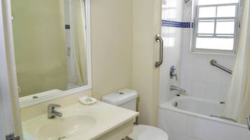 A bathroom with a sink, toilet, and bathtub.
