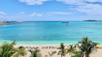 On the beach, white sand, sun-loungers, beach umbrellas