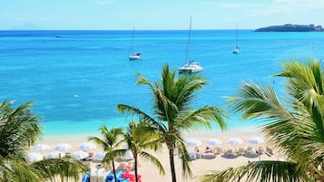 On the beach, white sand, sun loungers, beach umbrellas