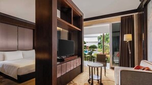 A hotel room with a bed, a television, a small table, and a sofa. - Swiss-Belhotel Borneo Banjarmasin (Banjarmasin)
