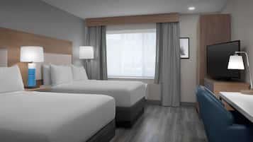 Habitación de hotel con dos camas, un escritorio, un televisor y una ventana con cortinas.