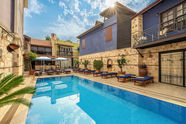 Outdoor pool, open 9 AM to 6 PM, pool umbrellas, pool loungers