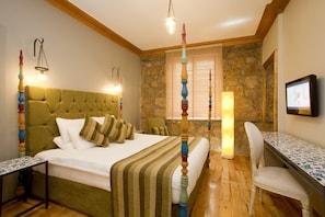 Cozy retreat with a tufted headboard, striped bedding, and a comfortable bed.