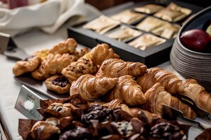 A variety of pastries including croissants and muffins on a tray. - The Claremont  (Douglas)