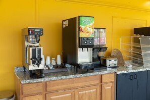 A coffee station with a coffee machine, a juice dispenser, and a toaster. - Signature Inn Branson (Branson)