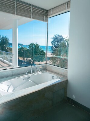 Family Two-Bedroom Beachfront Residence. | Deep soaking bathtub