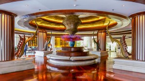 A spacious lobby with a central fountain, polished wooden floors, and a curved ceiling. - Paradox Resort Phuket (Karon)