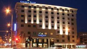 A hotel with a modern design, featuring a prominent "Golden Tulip" sign at the top. - Golden Tulip Varna (Varna)
