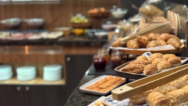 A buffet with various food items including pastries and fruits. - Golden Tulip Varna (Varna)
