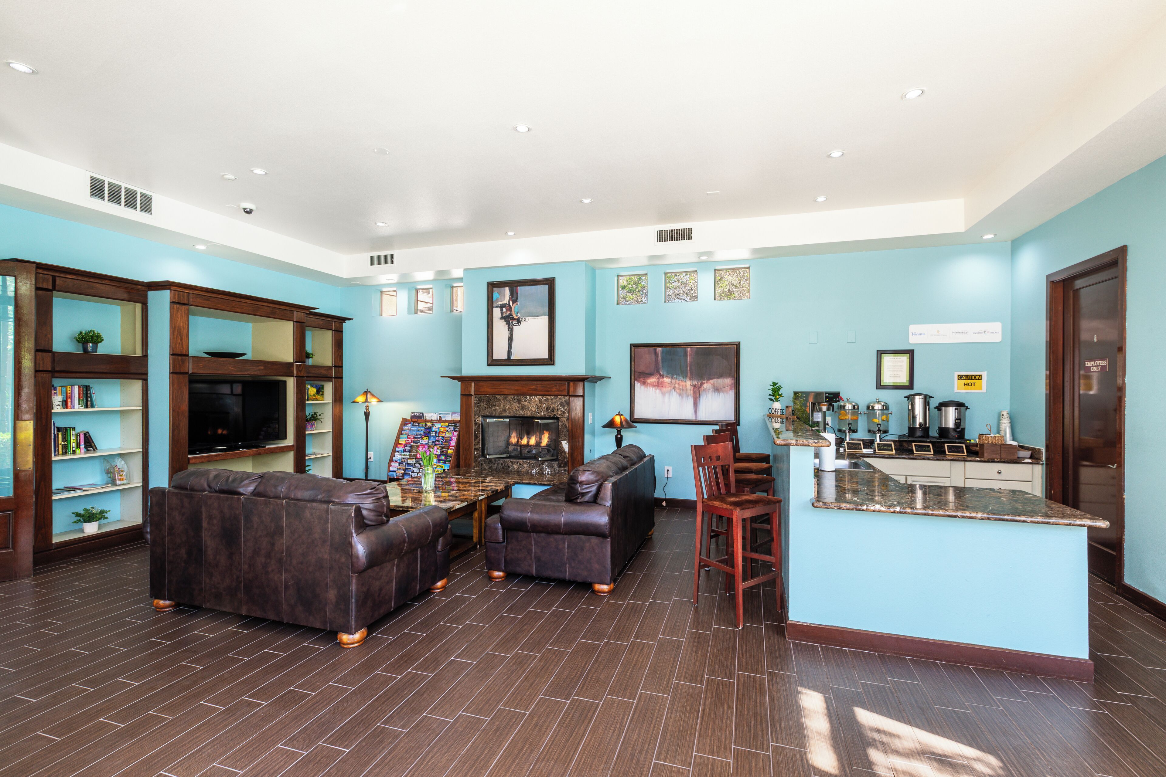 A spacious living area with a fireplace, a bar, and a seating area with sofas.