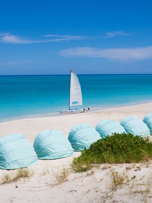 On the beach, white sand, sun loungers, beach towels
