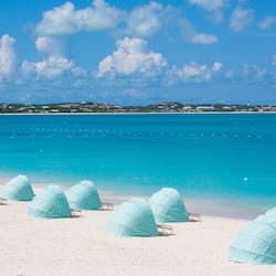 On the beach, white sand, sun loungers, beach towels