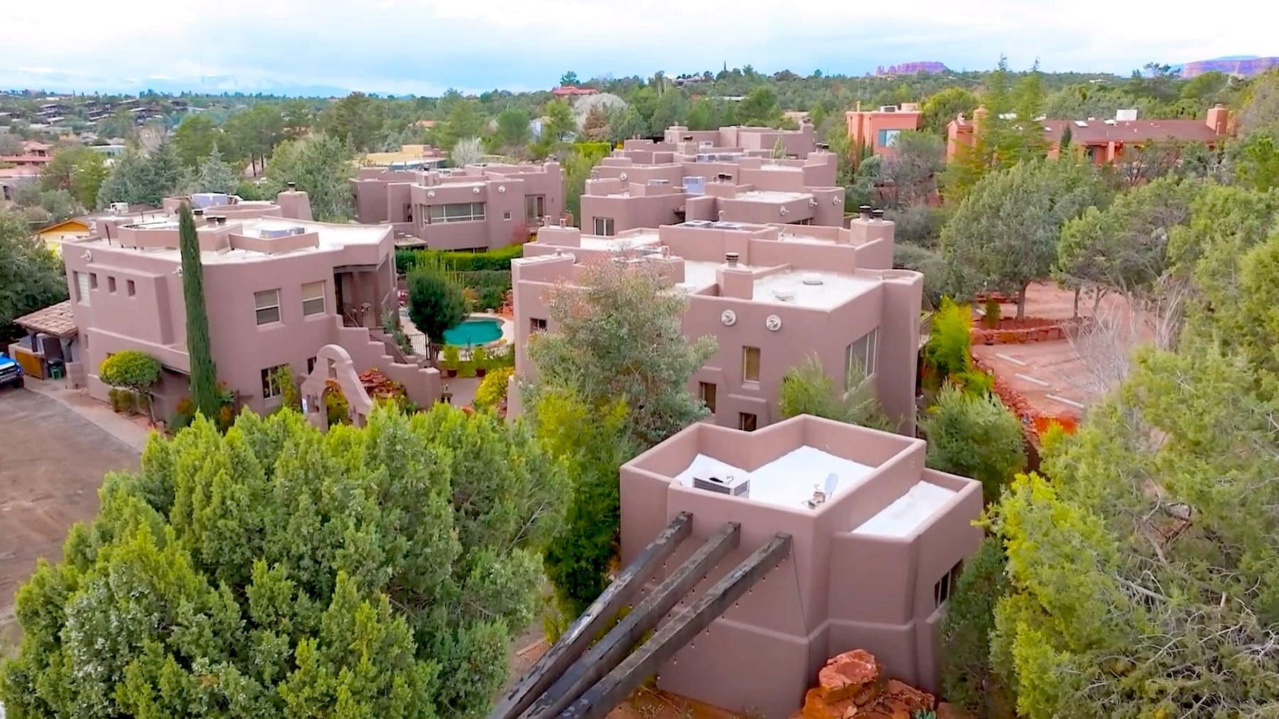 A residential area with multiple buildings, a swimming pool, and a slide.