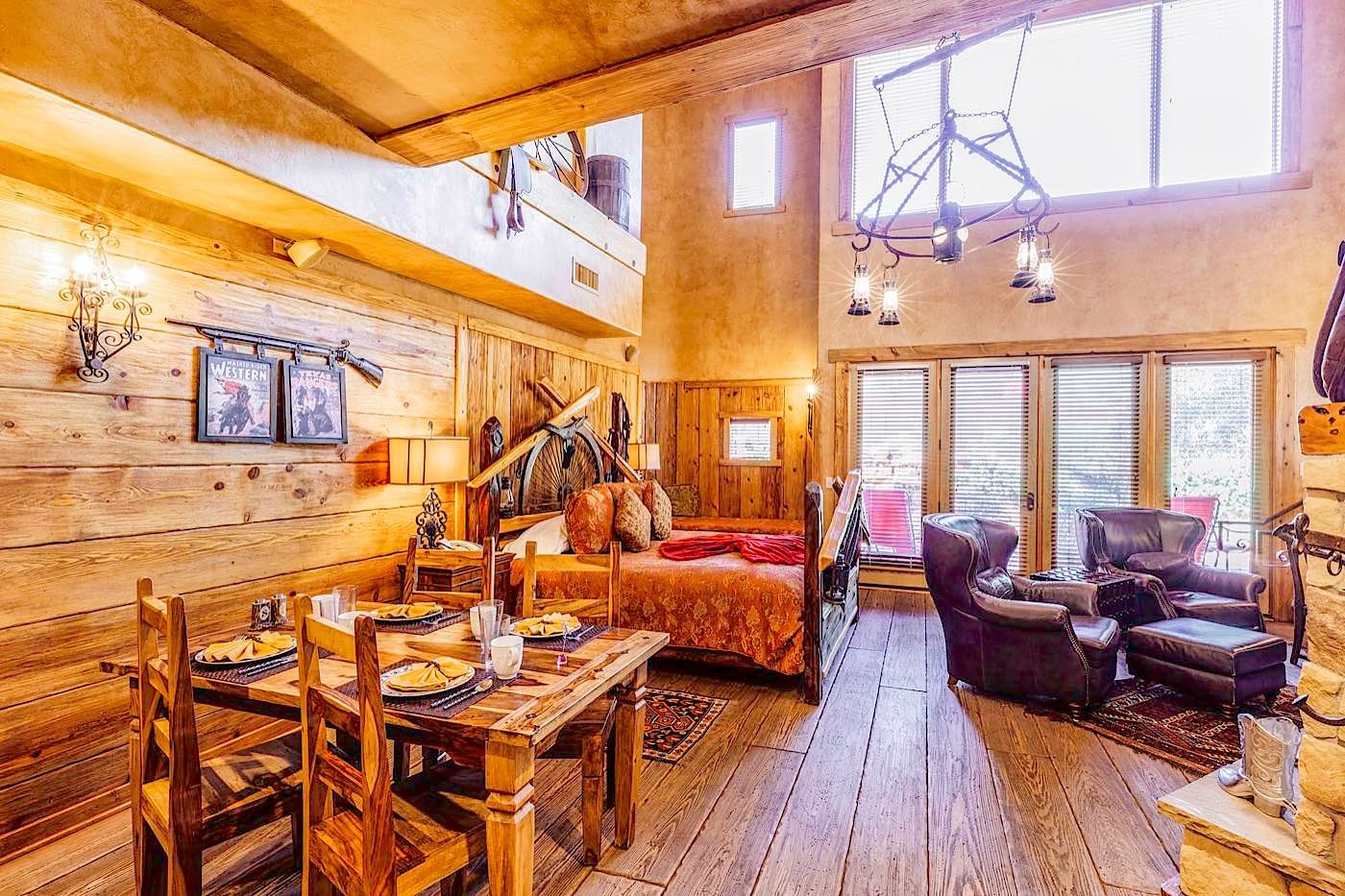 Un interior rústico de madera con un comedor, una cama y una zona de estar.