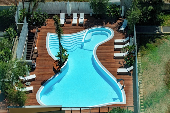 Seasonal outdoor pool, open 10:00 AM to 7:00 PM, pool umbrellas